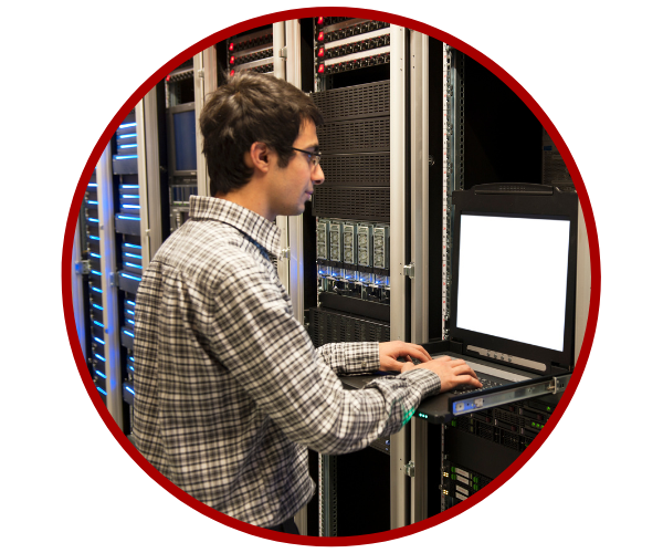 IT worker with laptop in server room